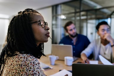 investors watch a presentation around a table
