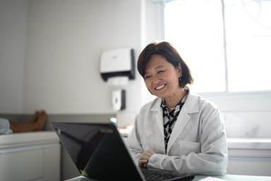 healthcare professional using a laptop