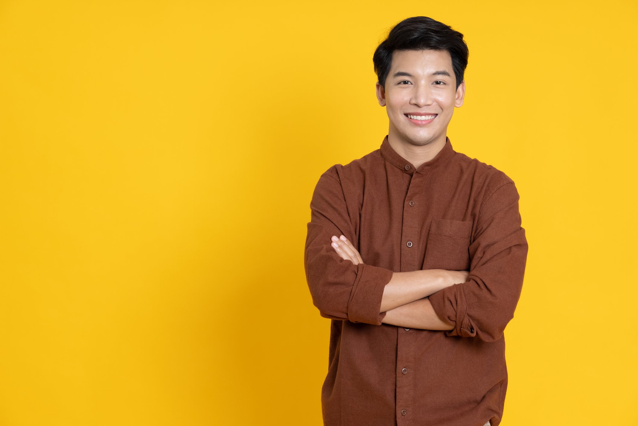Getty - smiling arms crossed yellow