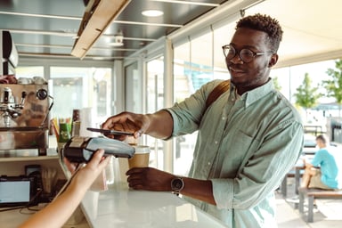 A person buying a cup of coffee