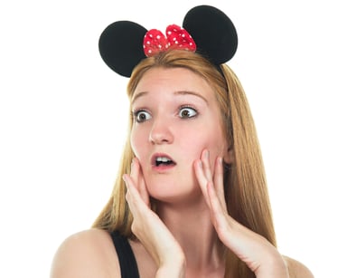 Alarmed young woman wearing mouse ears.