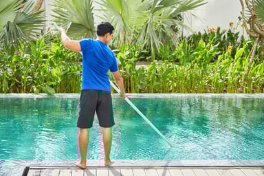 Man cleaning swimming pool