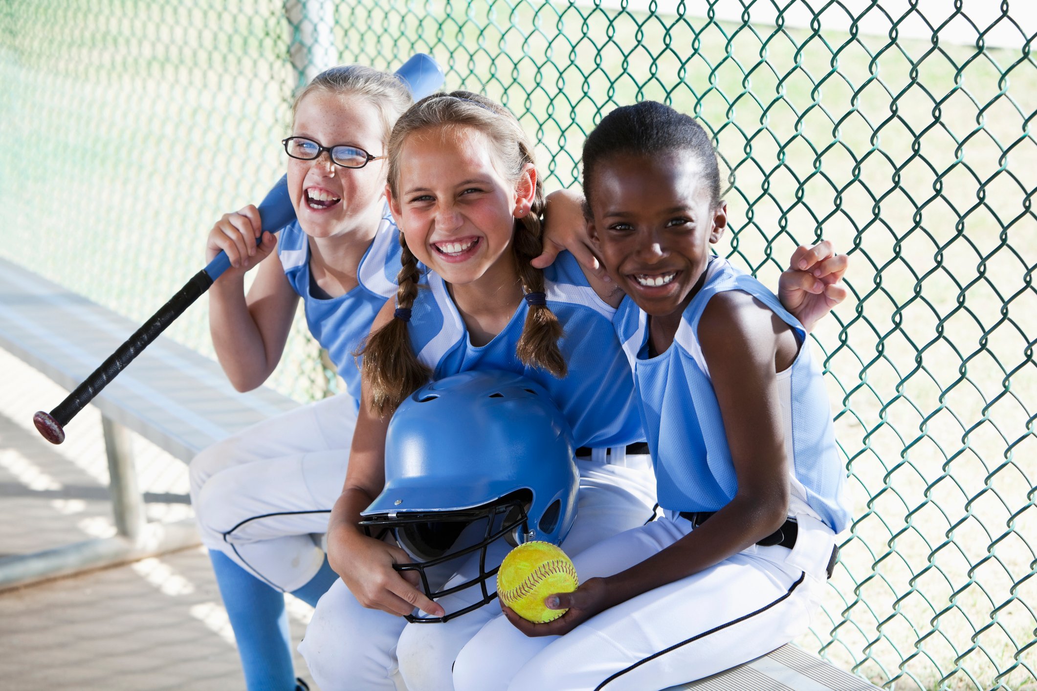 little girls softball team dugout