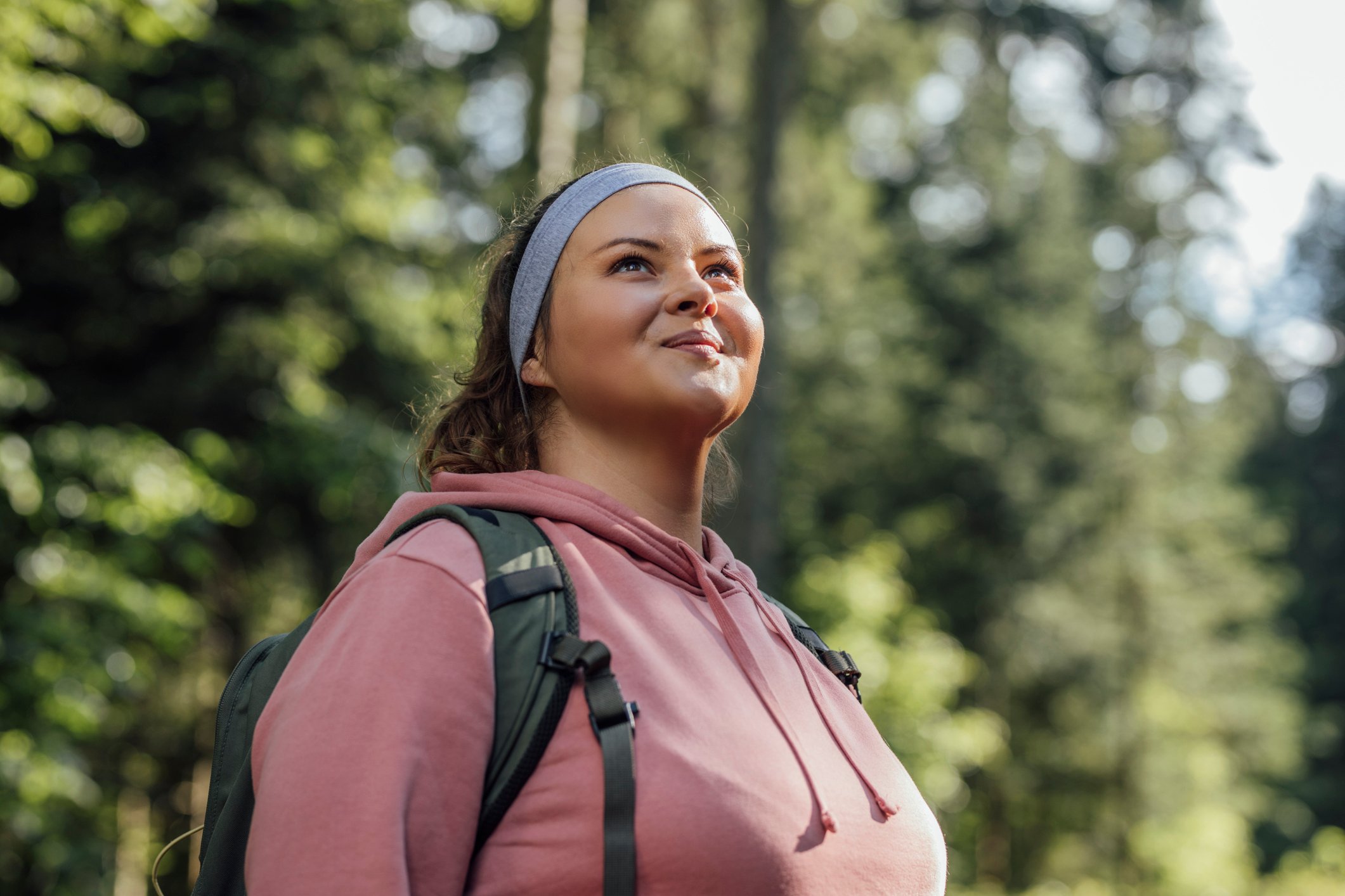 Someone is outdoors, looking up and smiling.
