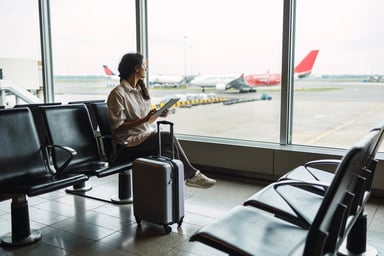 passenger looks at tarmac at airport.