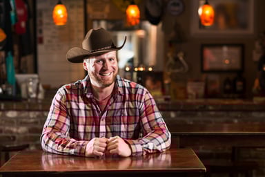 Getty - cowbow smiling in an establishment