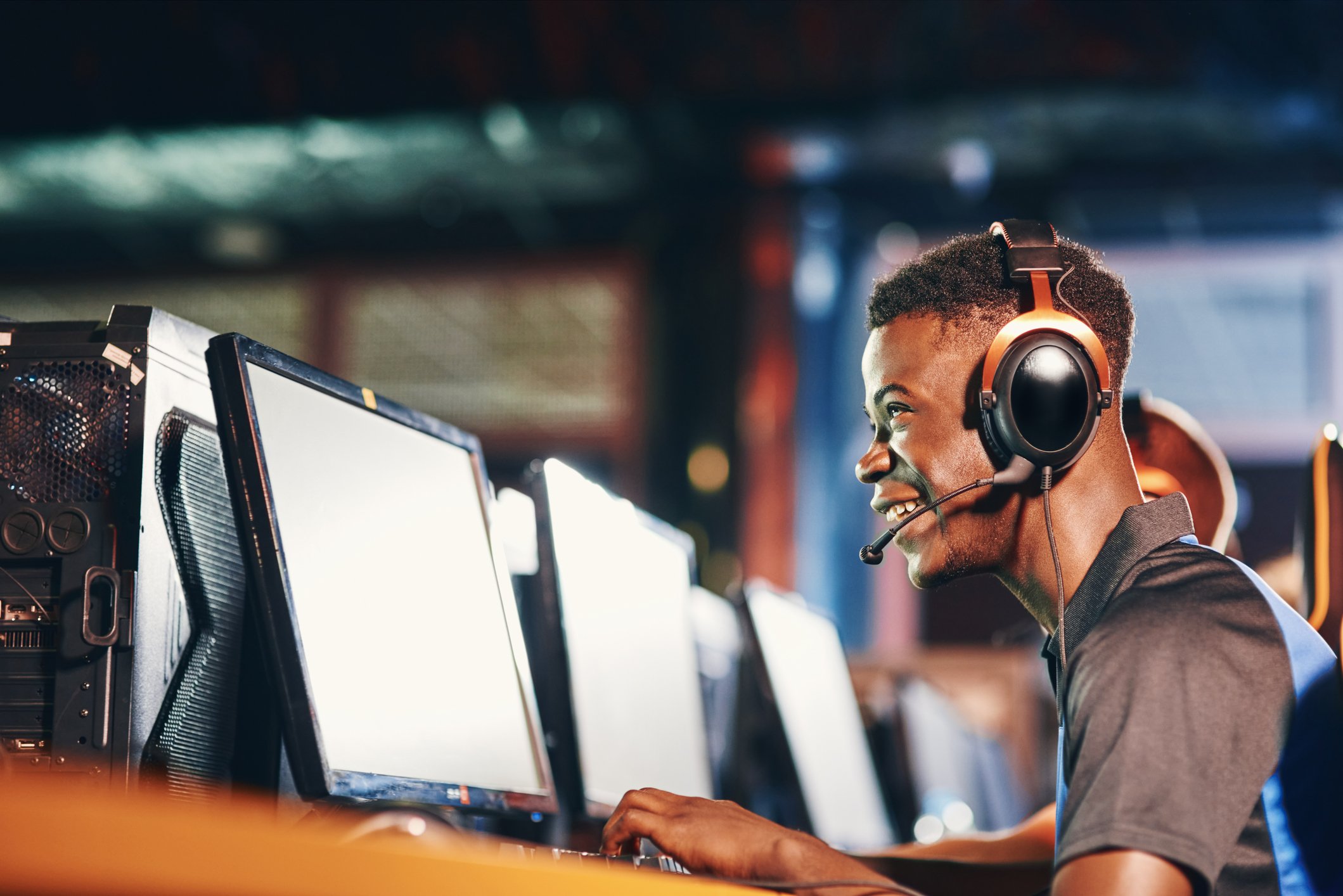 Man wearing headphones and looking at a computer