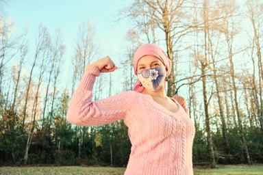 Cancer patient flexing muscle.