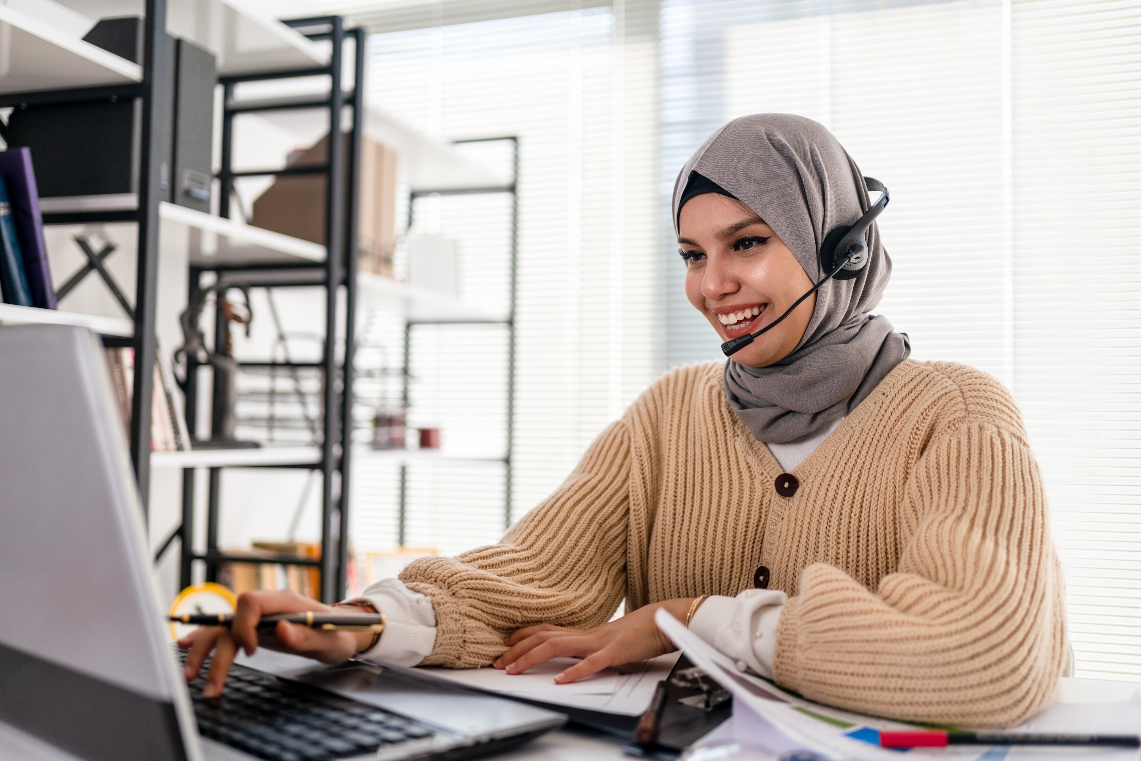 Person with headset and computer