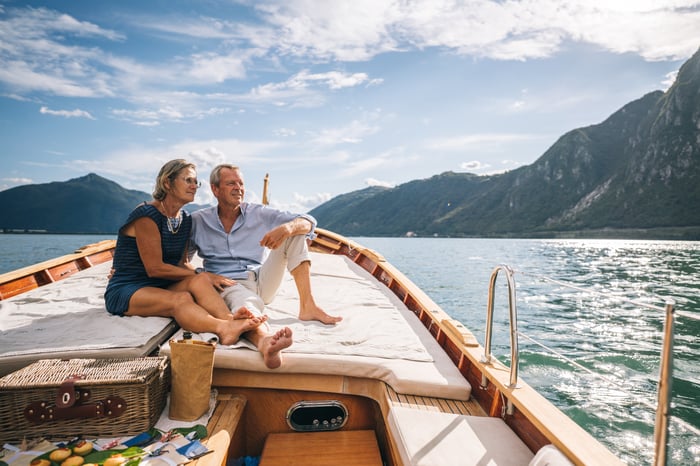 Couple sitting on boat looking off into the distance.