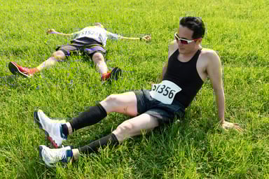 runners resting in grass
