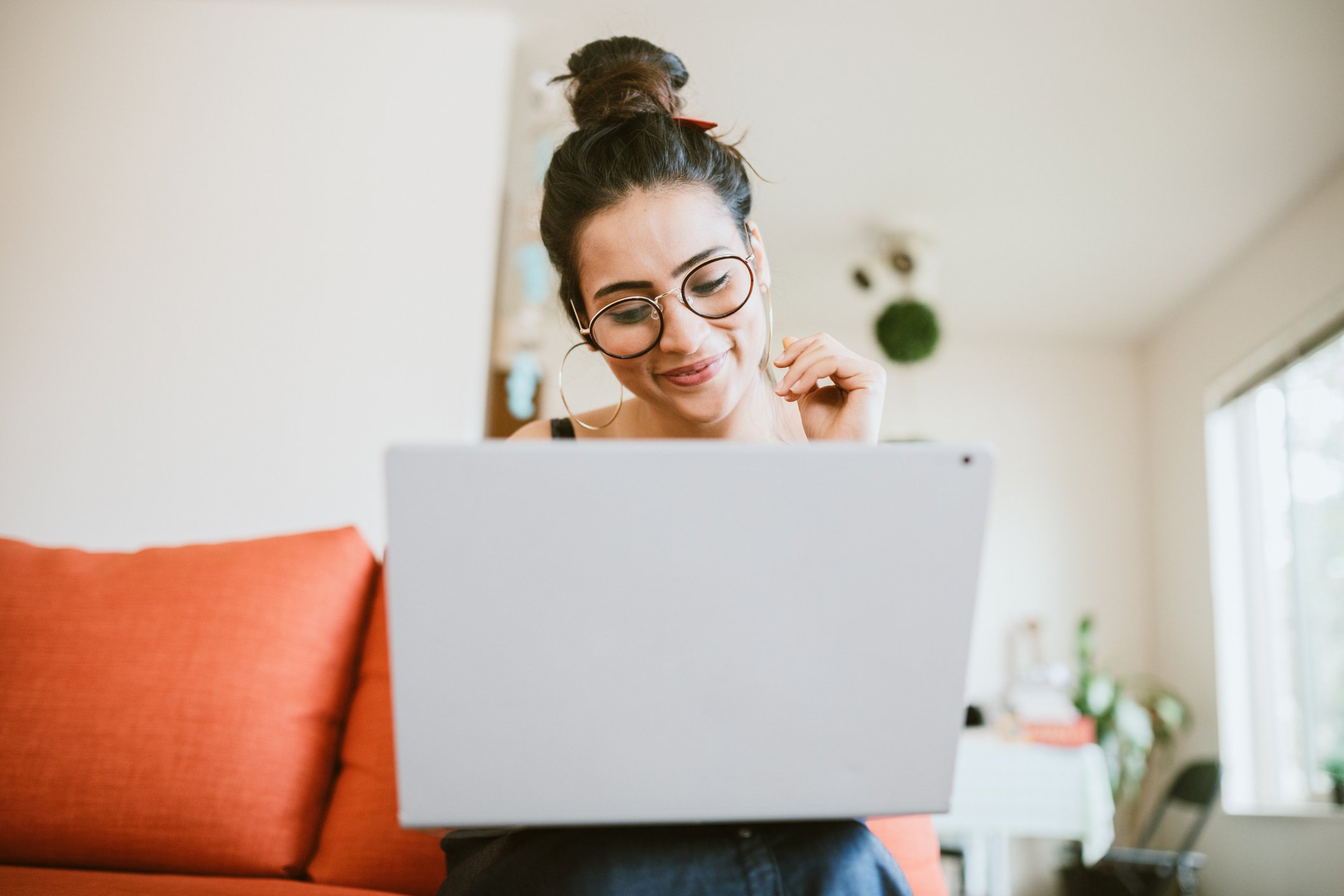 Smiling person looking at laptop
