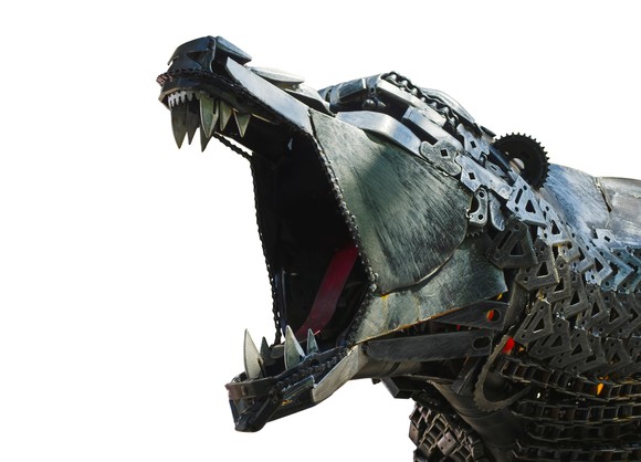 A roaring robot bear constructed from metal parts, chains, and gears.