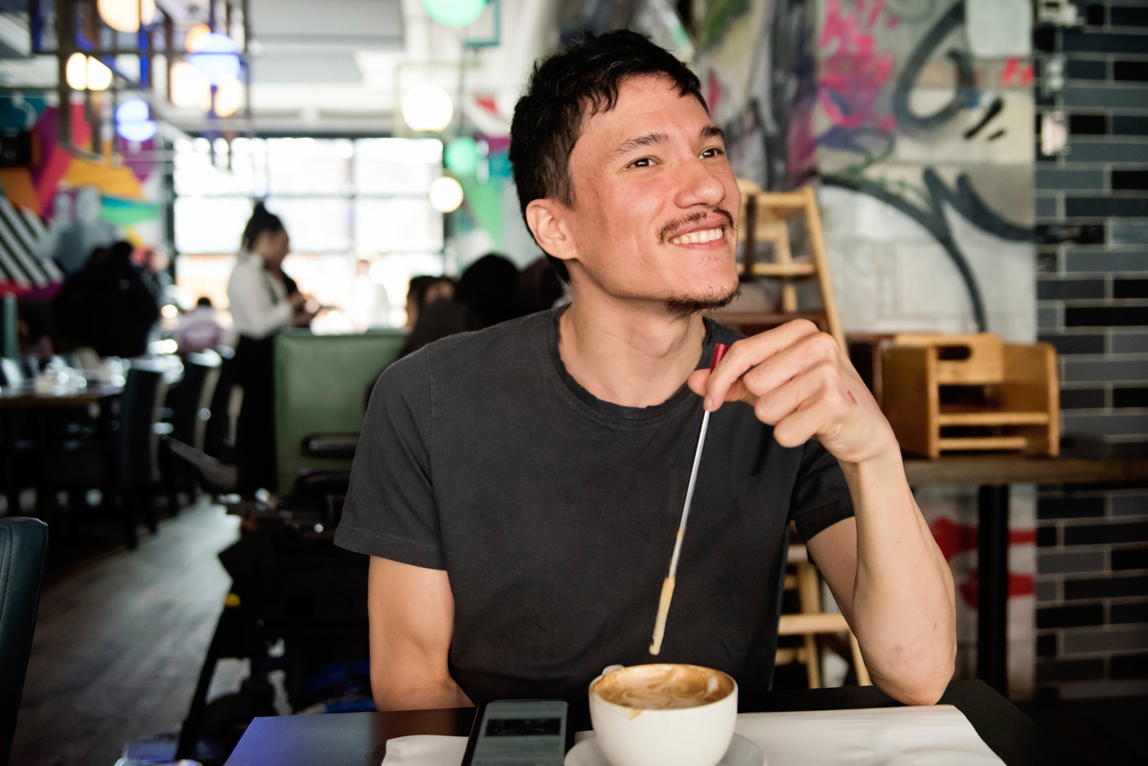 A customer drinks coffee at a coffee shop.