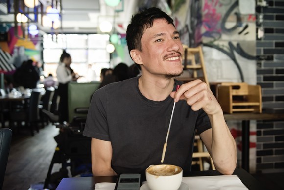 A customer drinks coffee at a coffee shop.