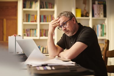 worried investor looking at computer