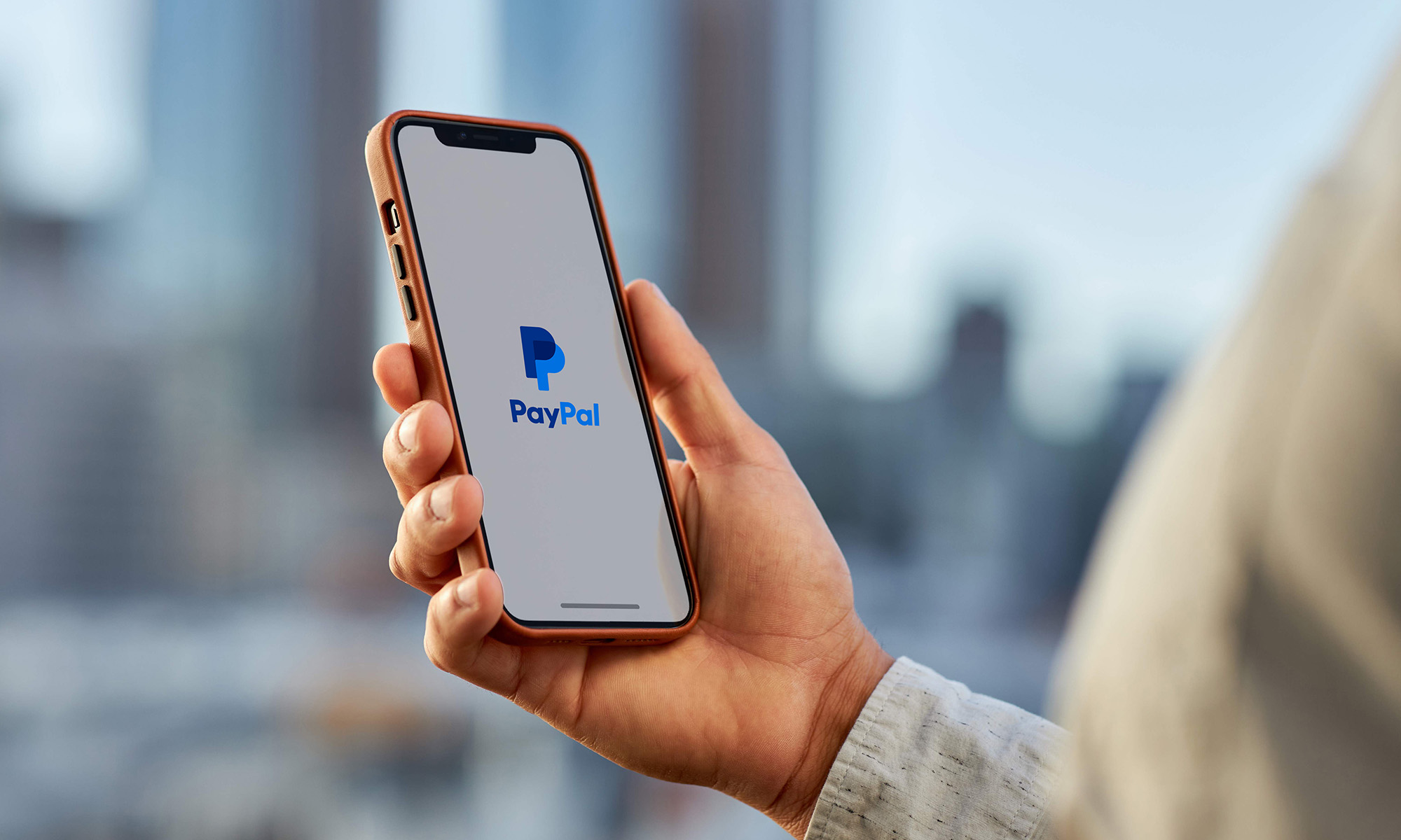person holding phone with PayPal app 1_PayPal