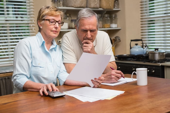 Two people looking at a document.