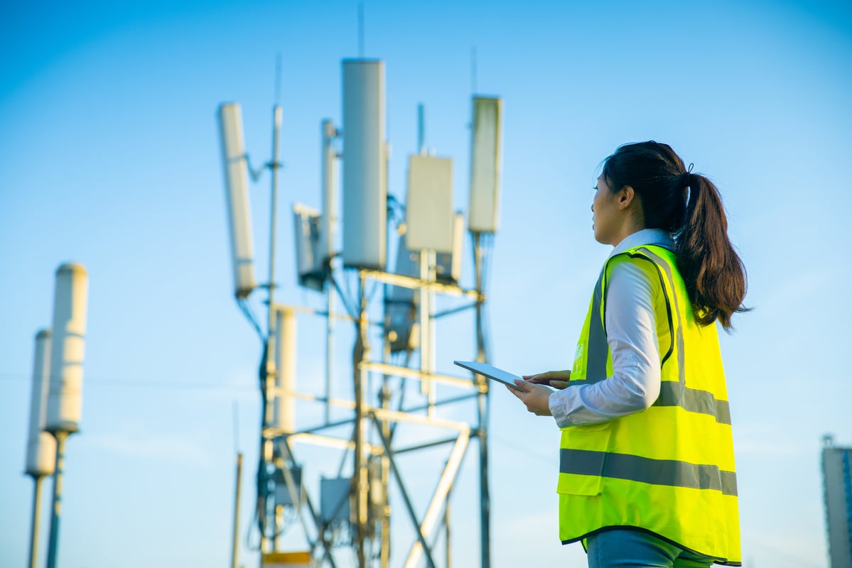 Technician working at a communications tower.