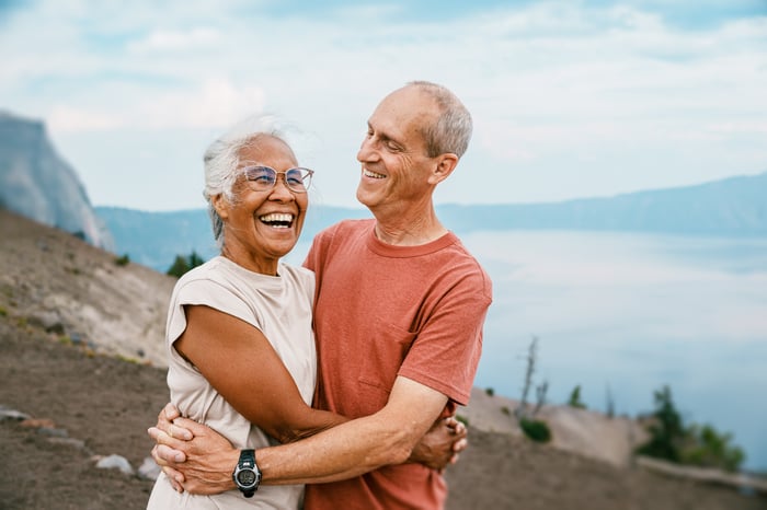 Two people hugging outdoors.