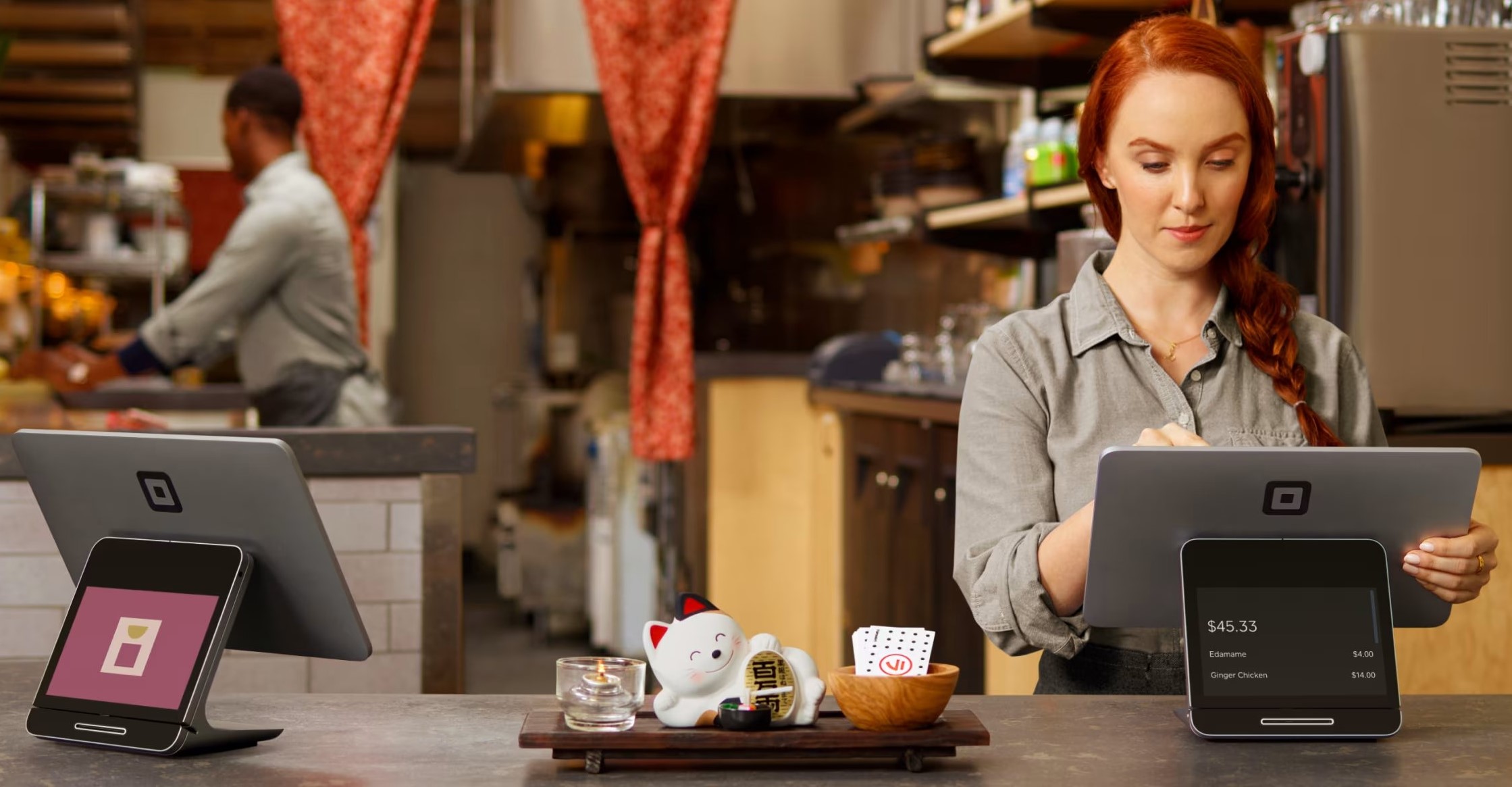 Two Square Registers being used in a restaurant.