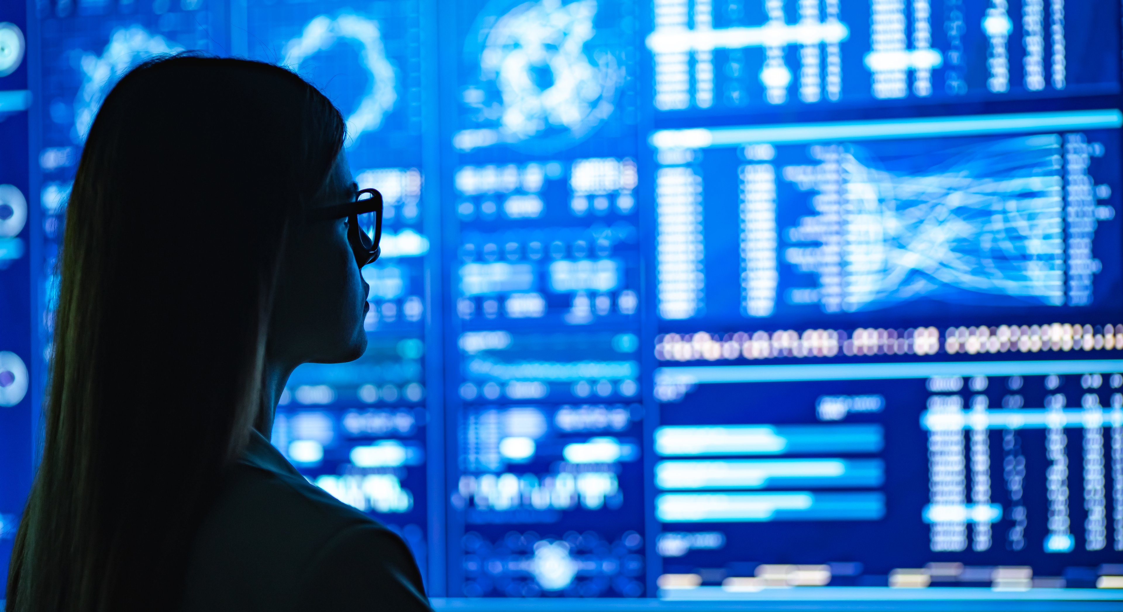 Person looking at charts on screen.