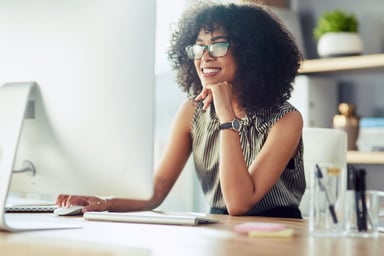 Person gazing happily at computer screen