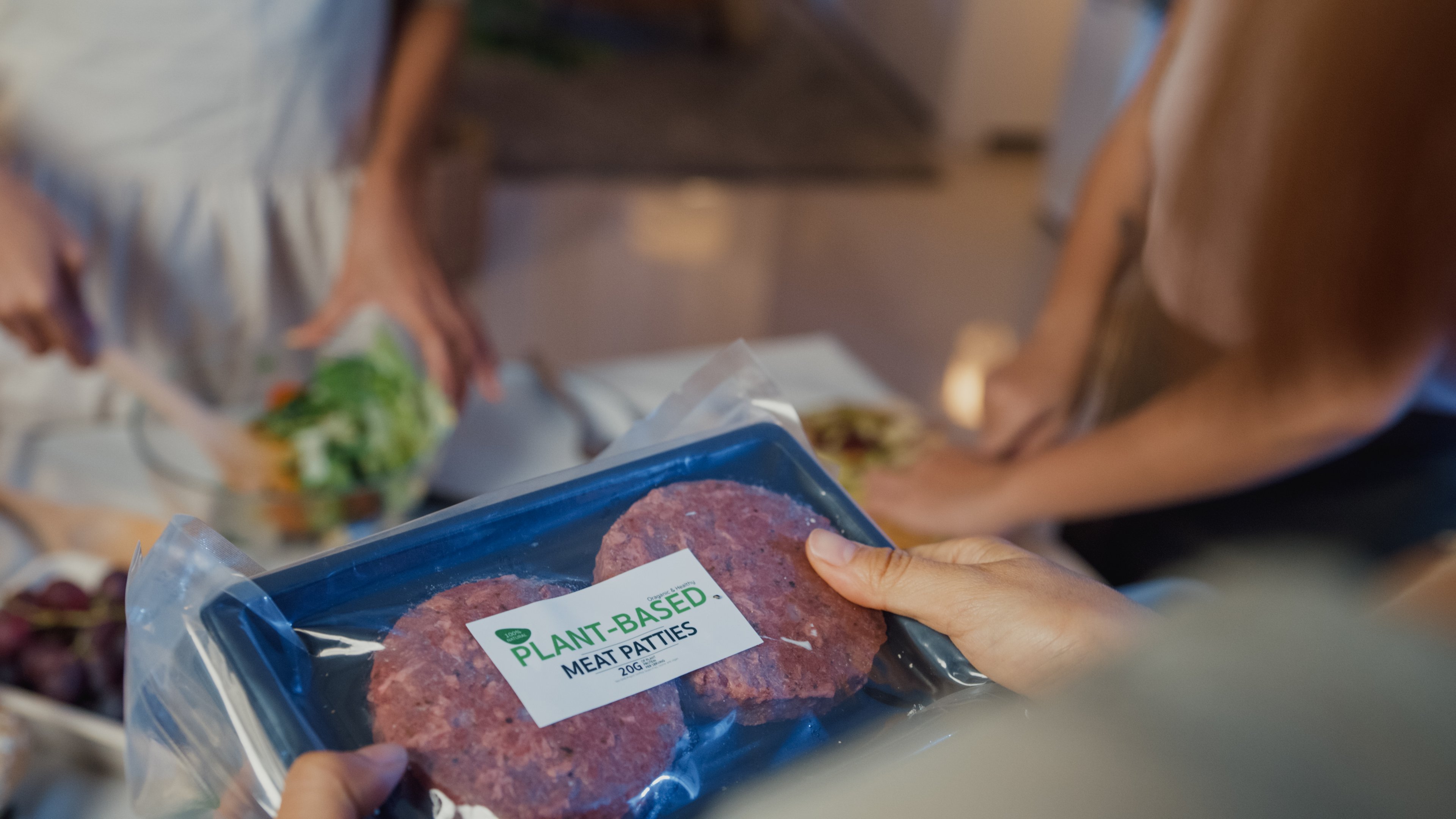 holding a package of plant-based meat