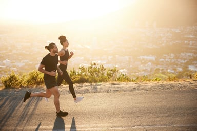 2 people running on road