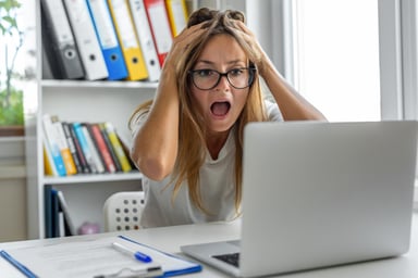 person screaming while looking at computer screen