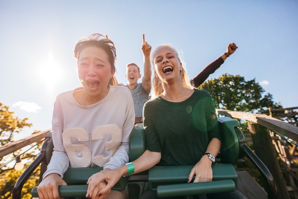 Four people riding a roller coaster.