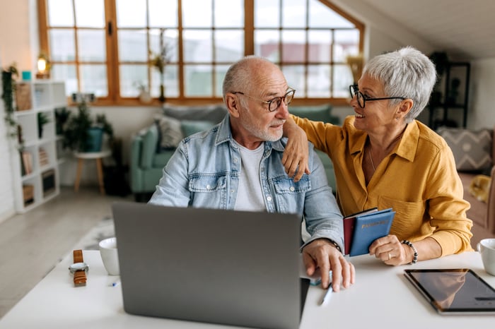 Two people at a laptop.