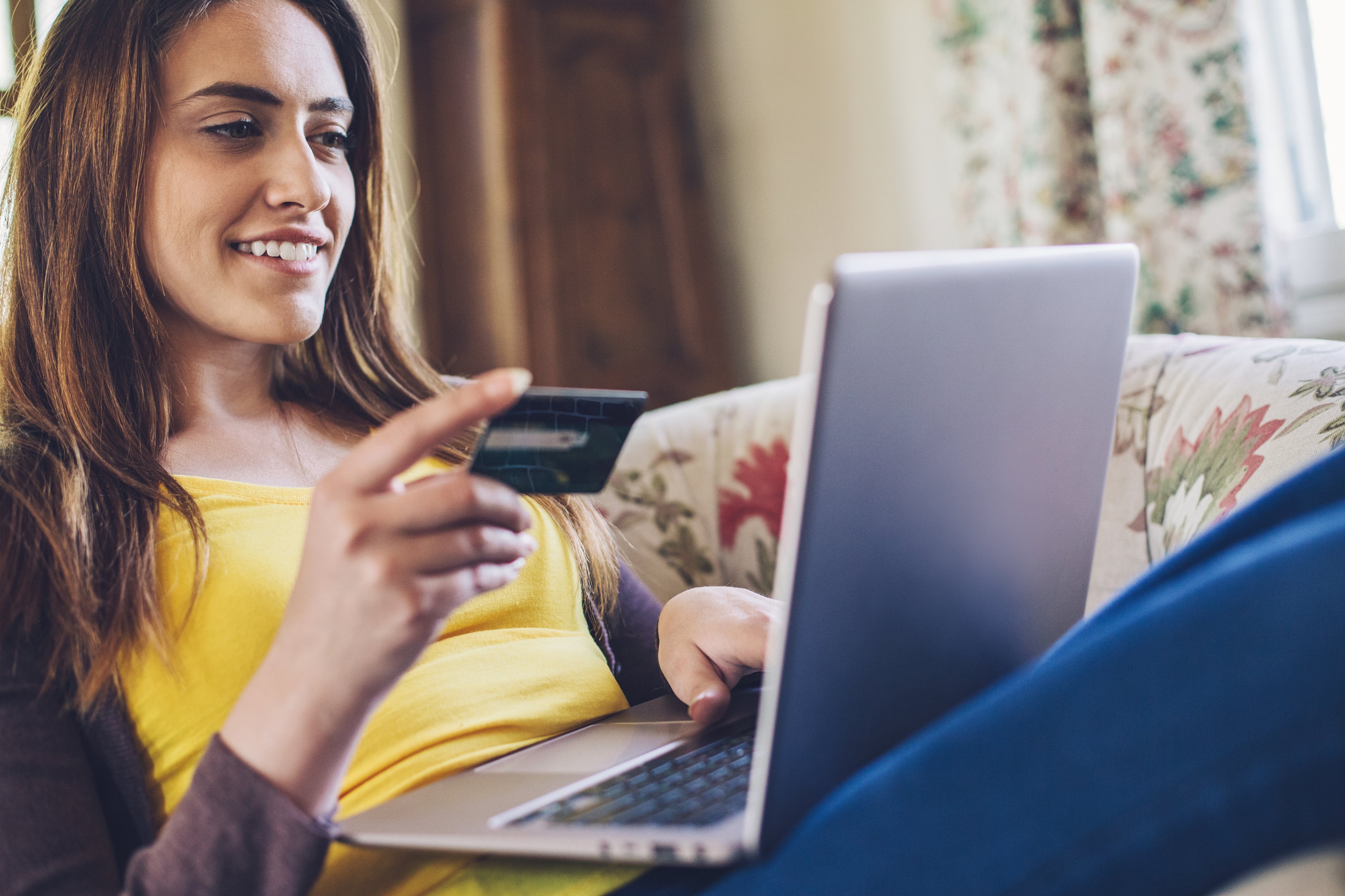 A shopper uses a credit card for an online purchase.