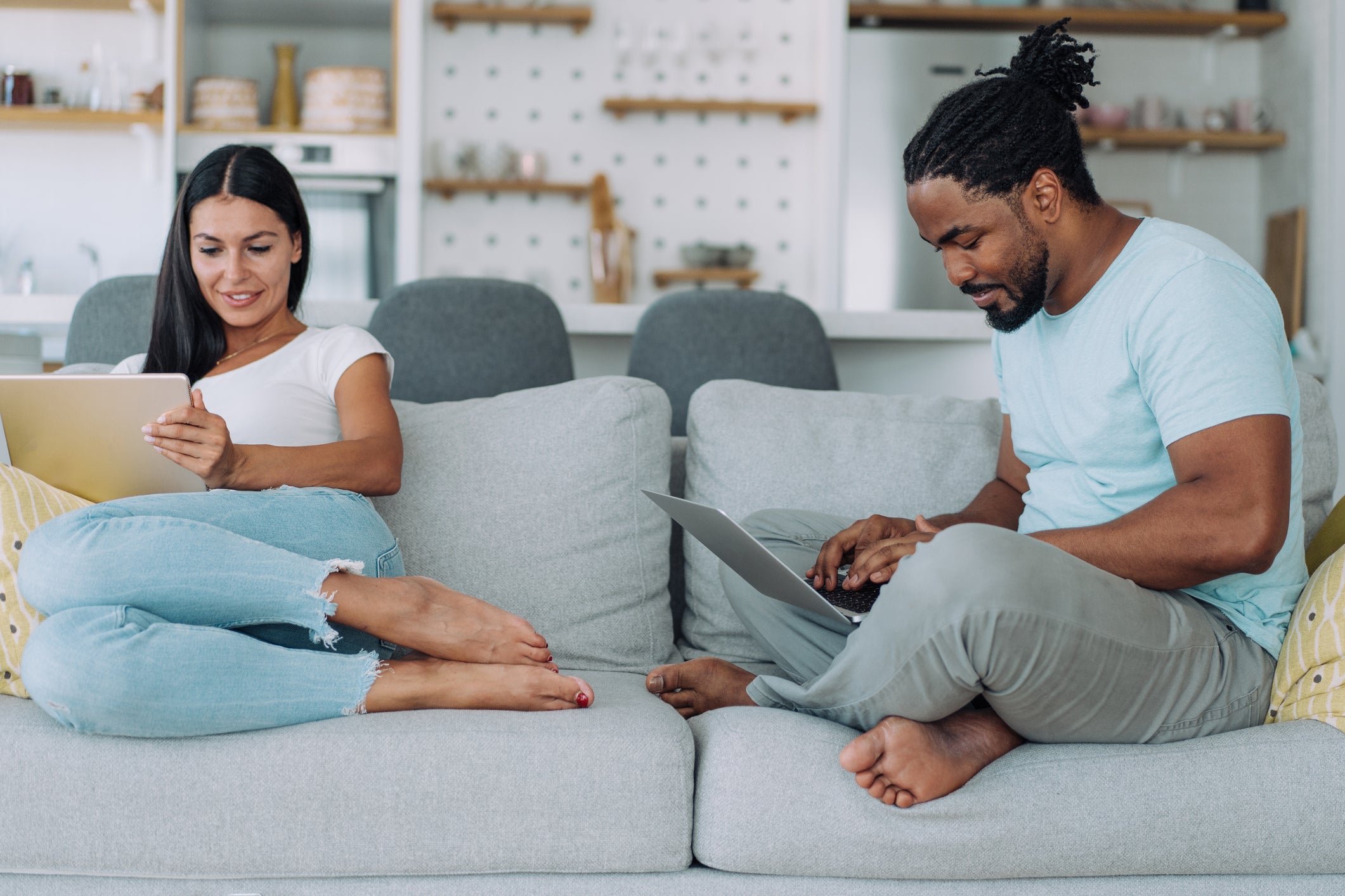 two-people-use-devices-at-home-getty