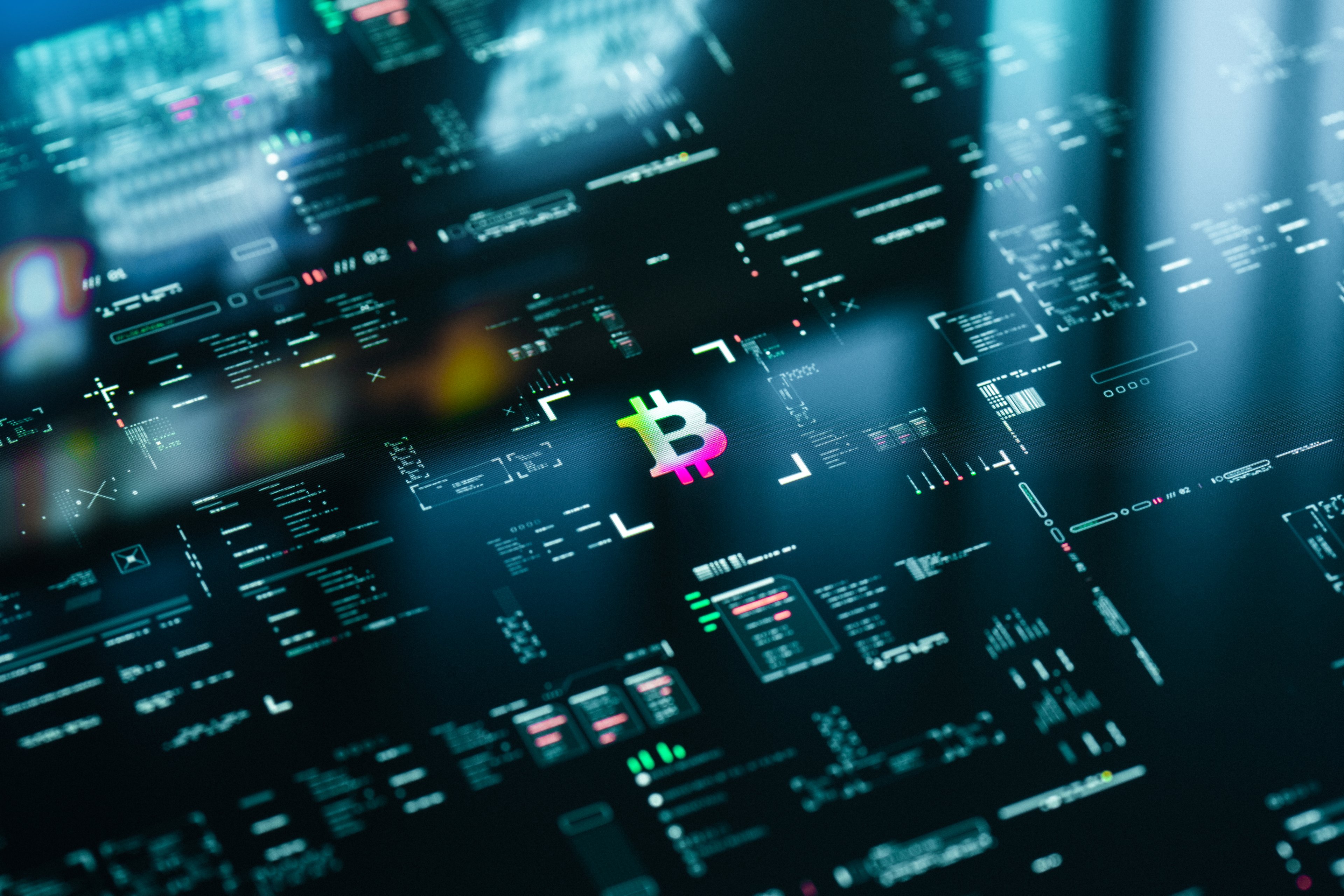 Neon Bitcoin symbol on digital trading screen.