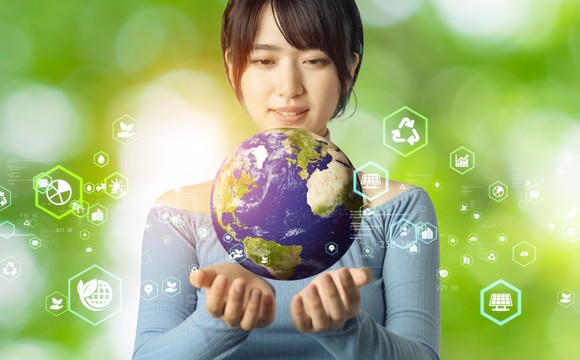 Woman holds globe in her hands. 