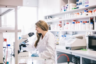 Female scientist observing with microscope