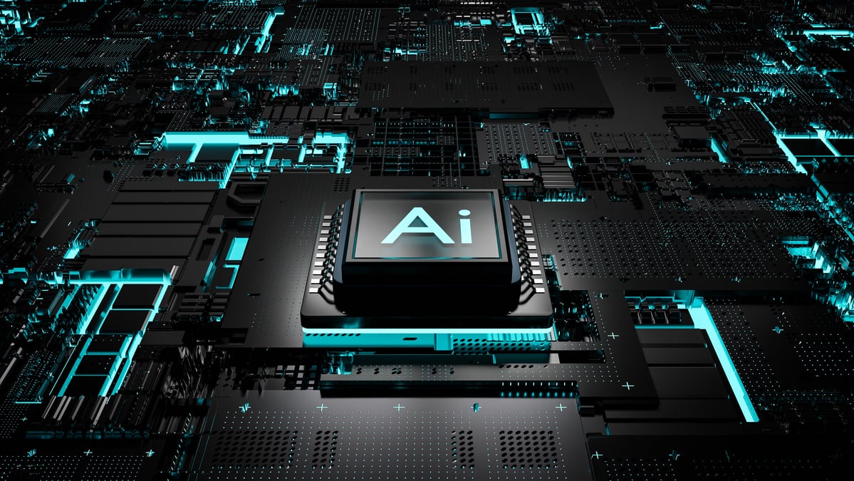 An AI chip on a black and teal motherboard.