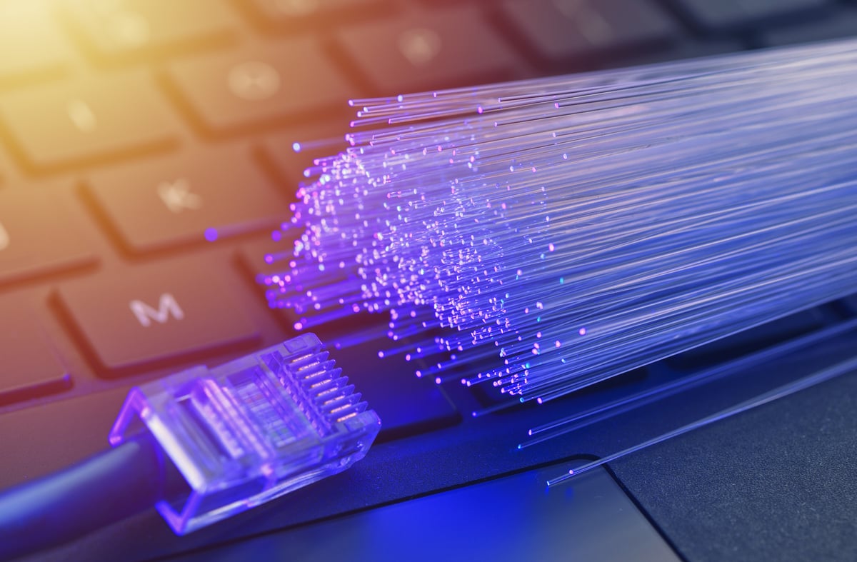 A rendering of an ethernet cable and rods of light sitting on top of a keyboard. 