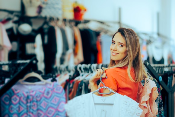 A person shopping for clothes in a store.