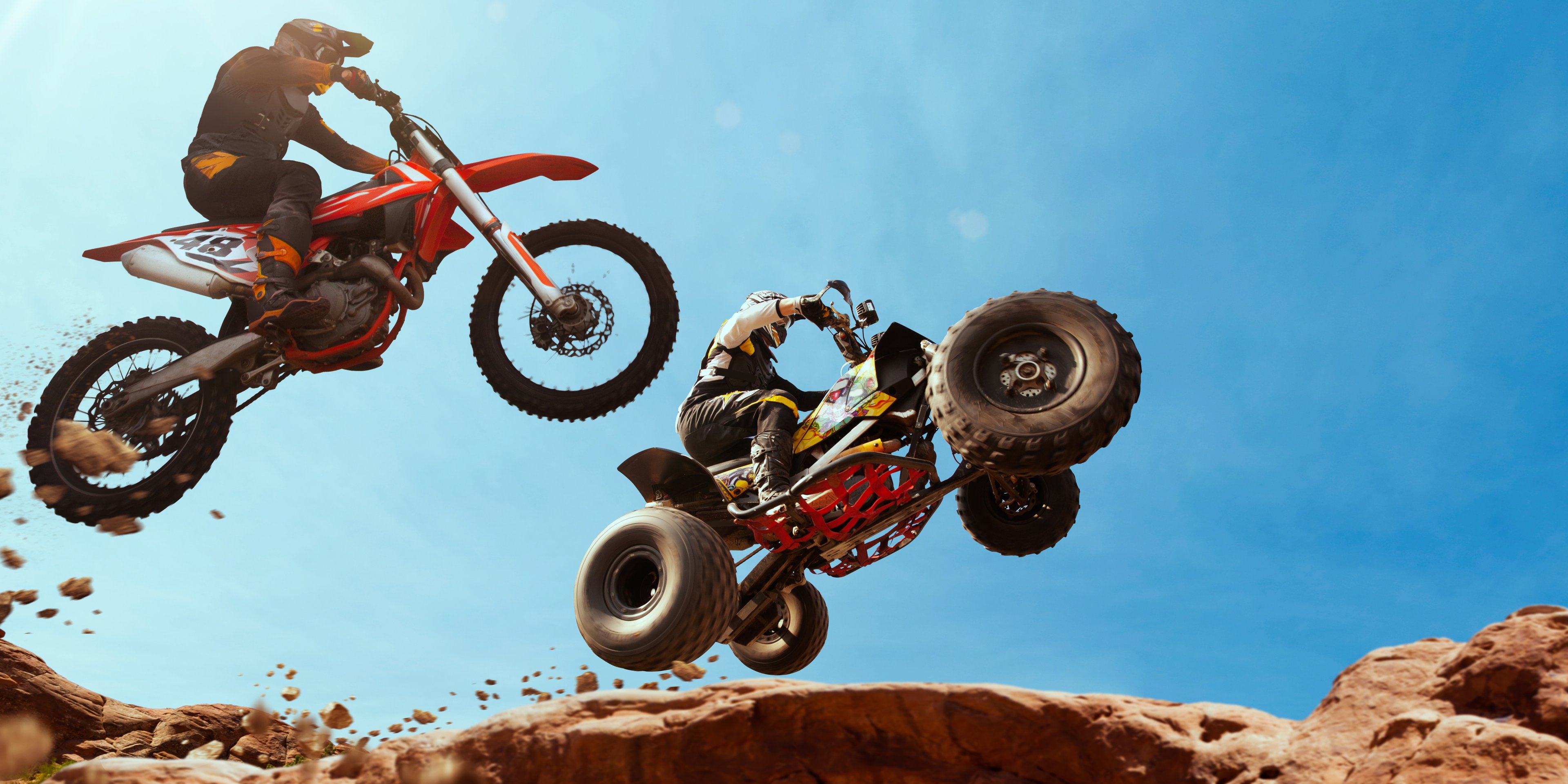 Two people tearing around in off road vehicles