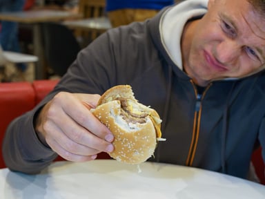 Upset person holding a hamburger.