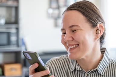 Getty - smiling at phone happy striped shirt