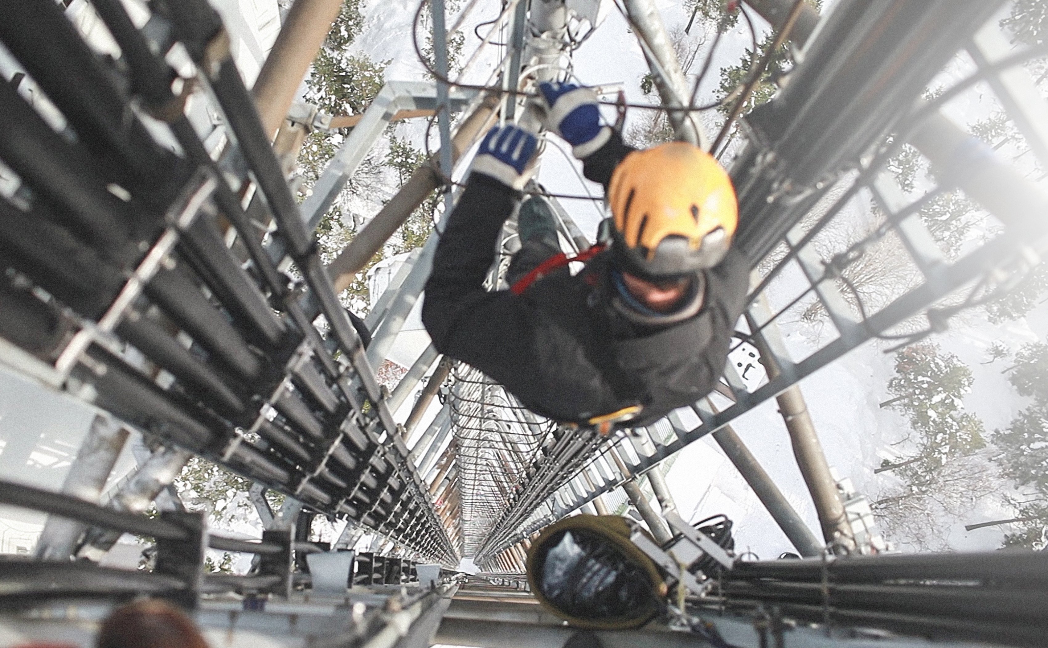 A worker climbing a cell tower.