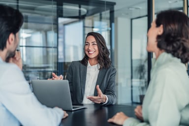 Woman with laptop and coworkers
