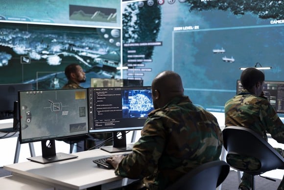 Military personnel using software at work.