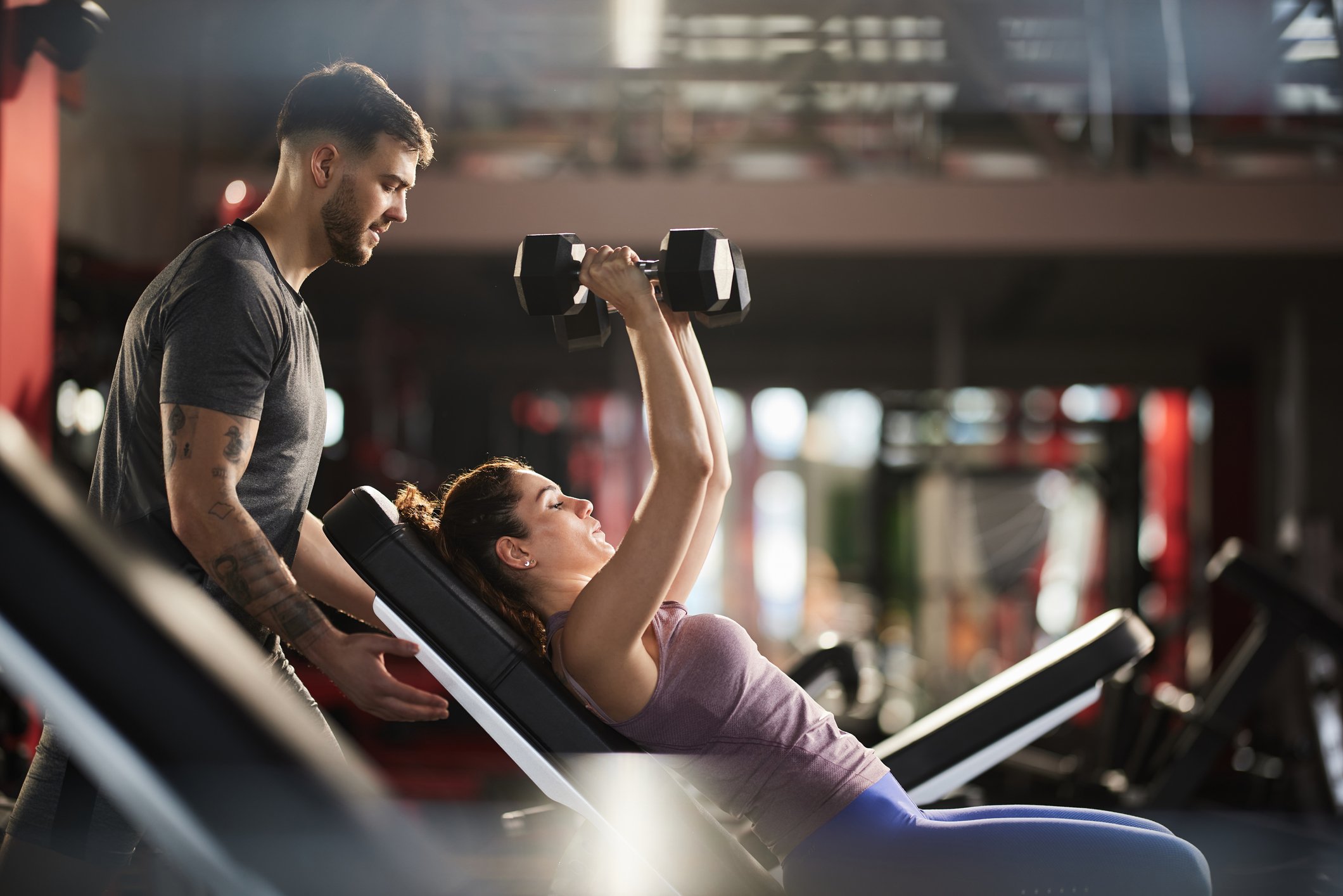 spotting lifter at gym