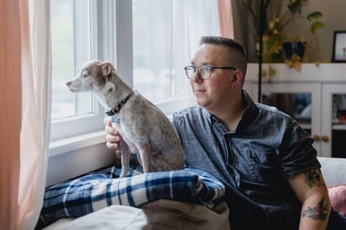 Getty - looking thoughtfully out window with dog