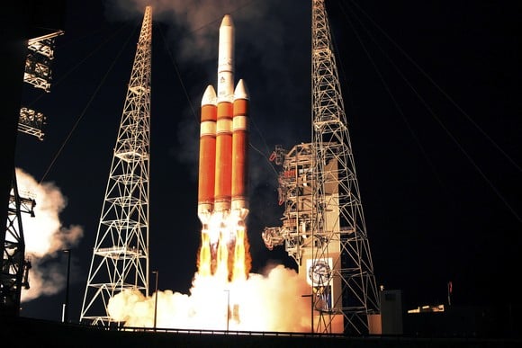 ULA Delta IV rocket launch at night.
