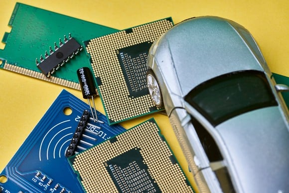 An model vehicle alongside related automotive electronic components.